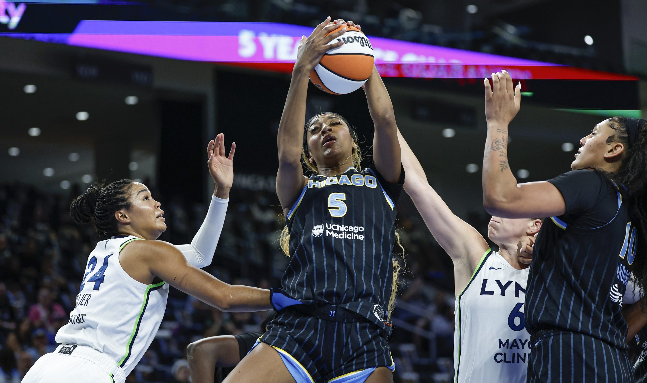 Chicago Sky forward Angel Reese (5) grabs a rebound against the Minnesota Lynx during the first half of a WNBA game at Wintrust Arena.