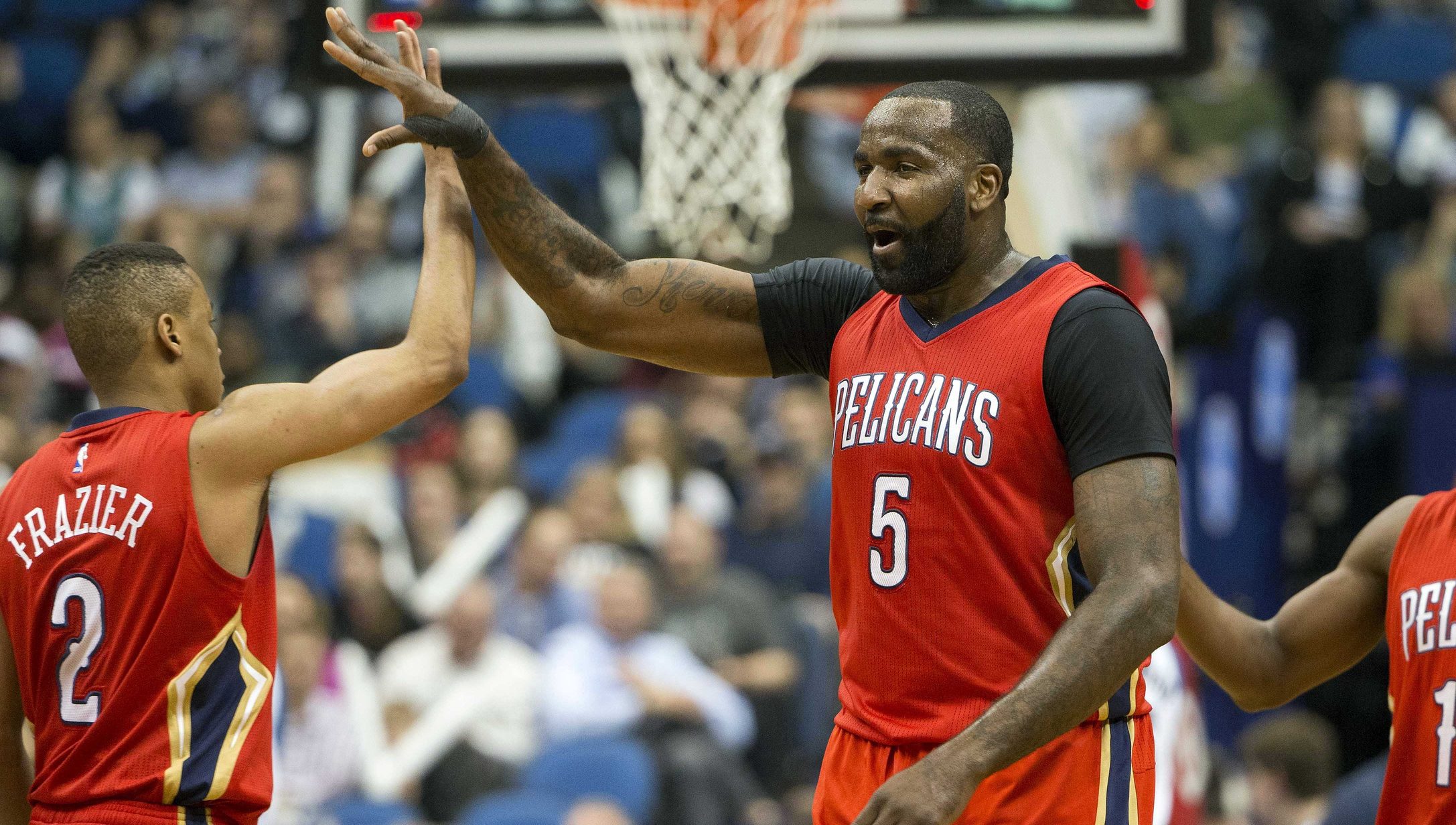 Apr 13, 2016; Minneapolis, MN, USA; New Orleans Pelicans center Kendrick Perkins (5) high fives New Orleans Pelicans guard Tim Frazier (2) after making a buzzer beater shot at the end of third quarter against the Minnesota Timberwolves at Target Center. The Timberwolves won 144-109. Mandatory Credit: Jesse Johnson-USA TODAY Sports