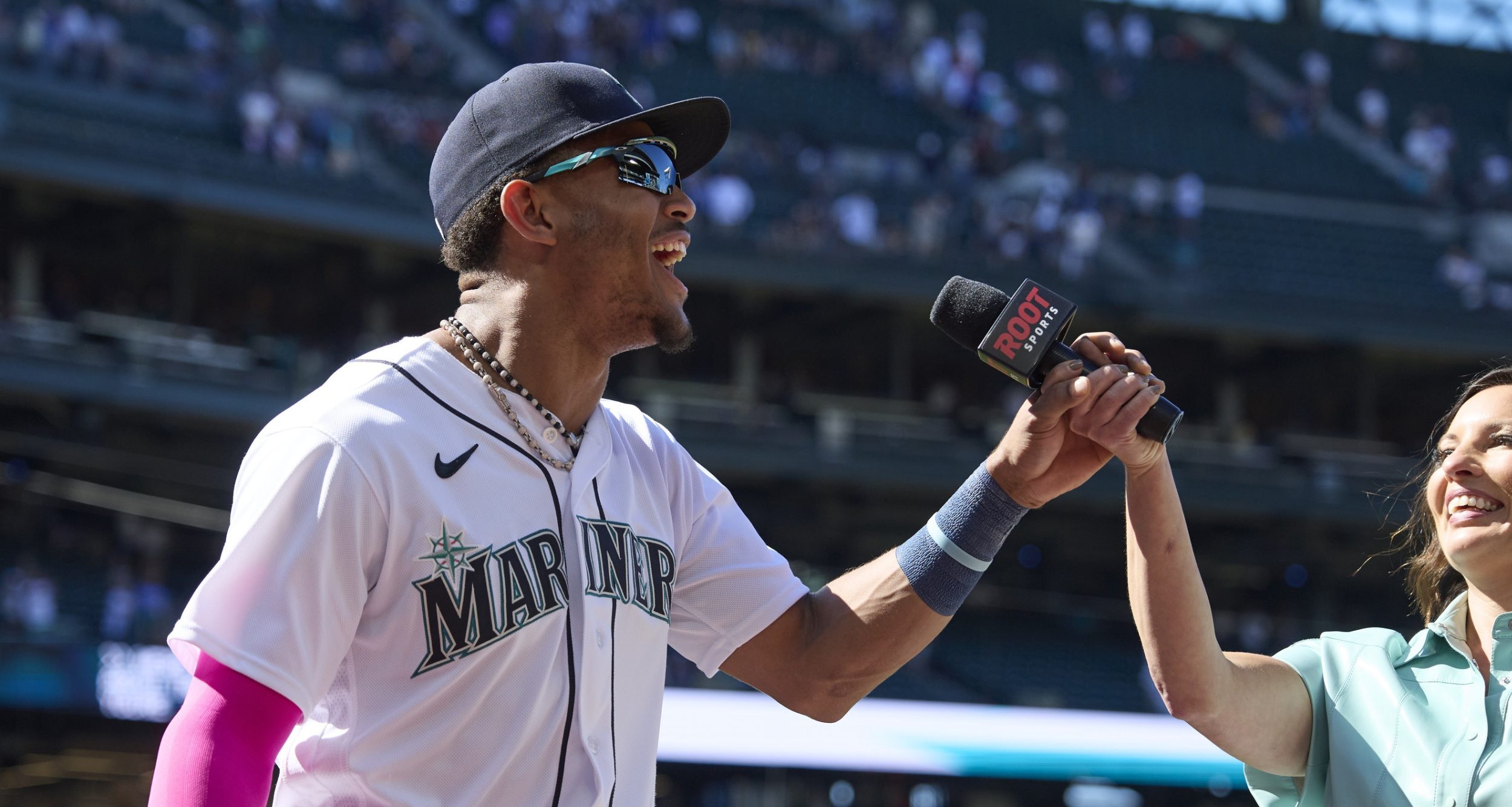 Seattle Mariners center fielder Julio Rodriguez grabs the microphone from Root Sports Jen Mueller after the win over the Boston Red Sox at T-Mobile Park.