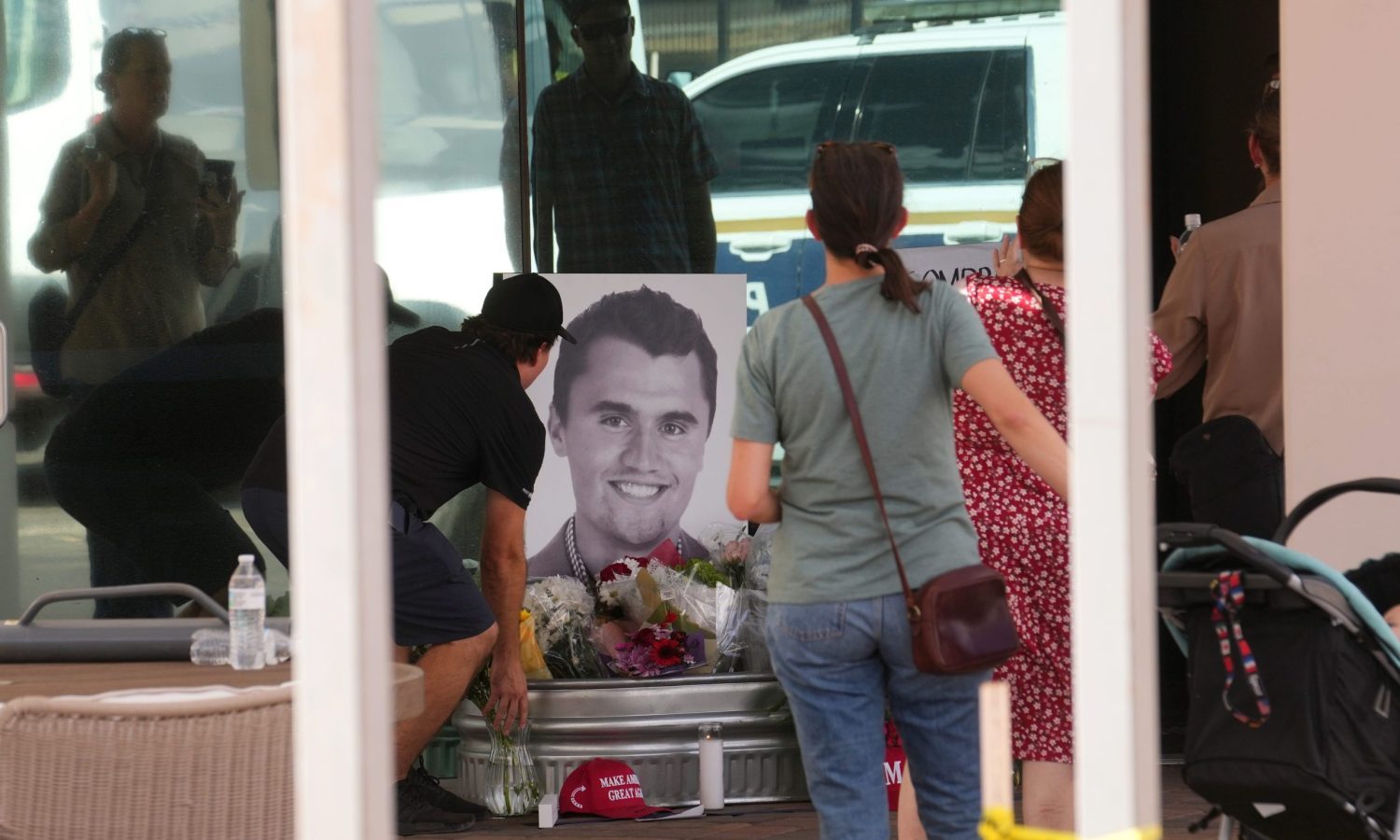 People congregate at Turning Point Headquarters in Phoenix after news that the founder, Charlie Kirk, was shot and killed at a rally in Utah on Sept. 10, 2025.