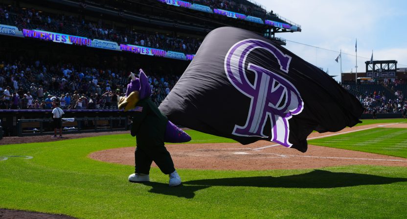 Jul 6, 2025; Denver, Colorado, USA; Colorado Rockies mascot Dinger celebrates defeating the Chicago White Sox at Coors Field. Mandatory Credit: Ron Chenoy-Imagn Images
