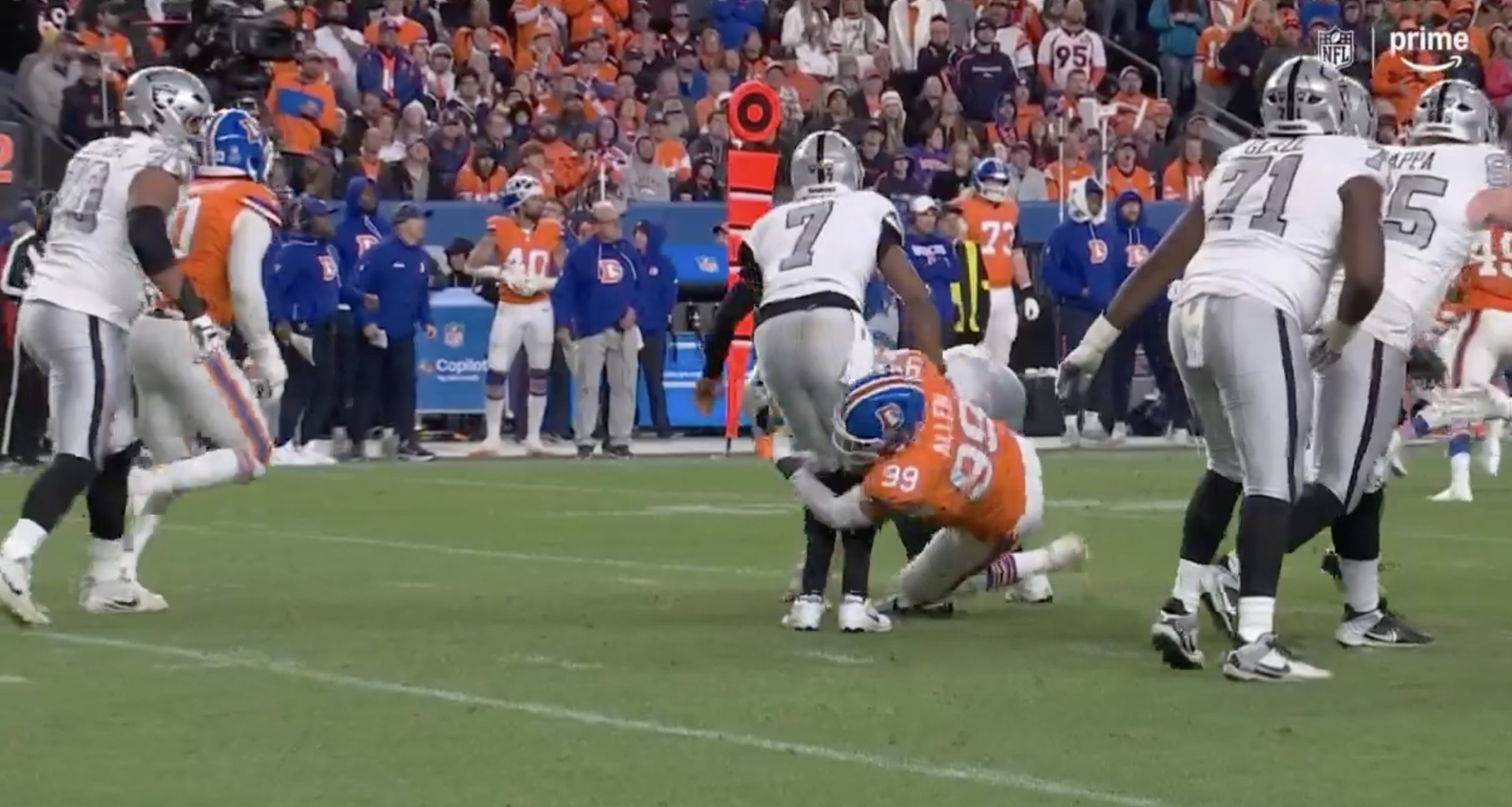 Geno Smith is tackled by Zach Allen after attempting a pass in Thursday's Raiders-Broncos game.