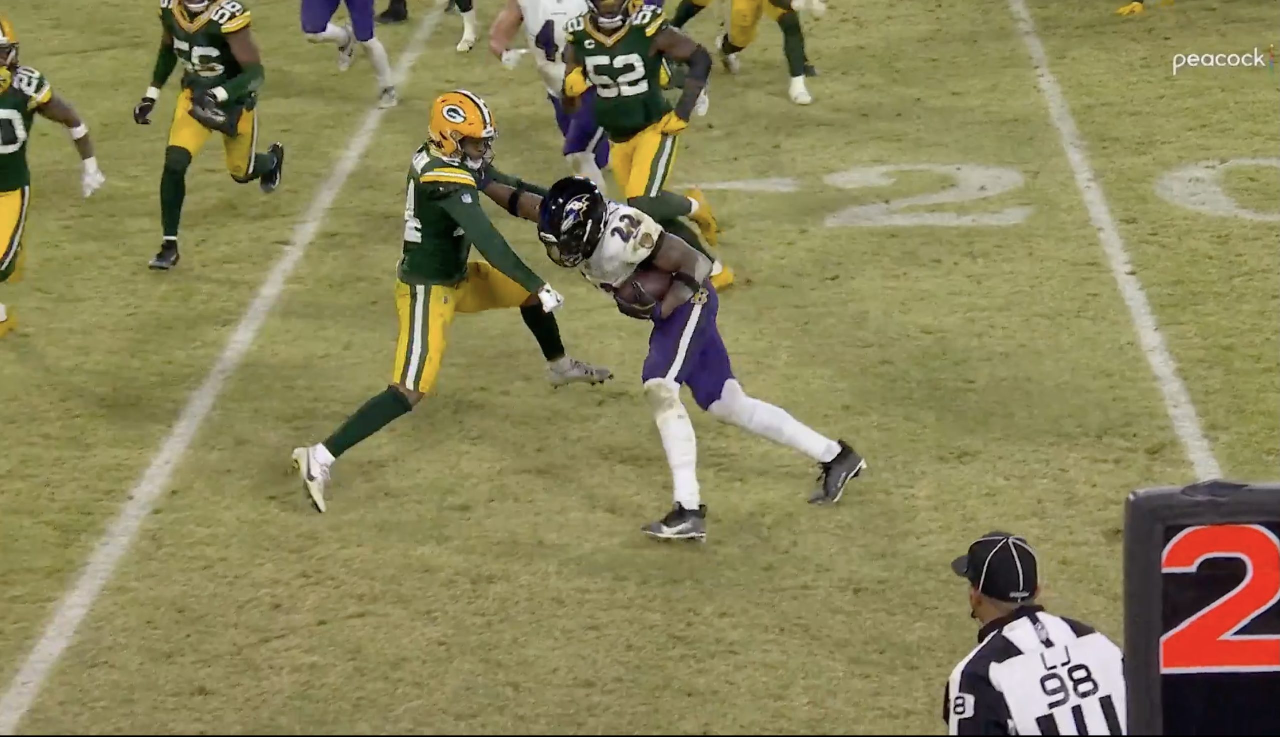 Baltimore Ravens running back Derrick Henry uses a stiff arm to toss Green Bay Packers cornerback Carrington Valentine at Lambeau Field. Photo Credit: Peacock