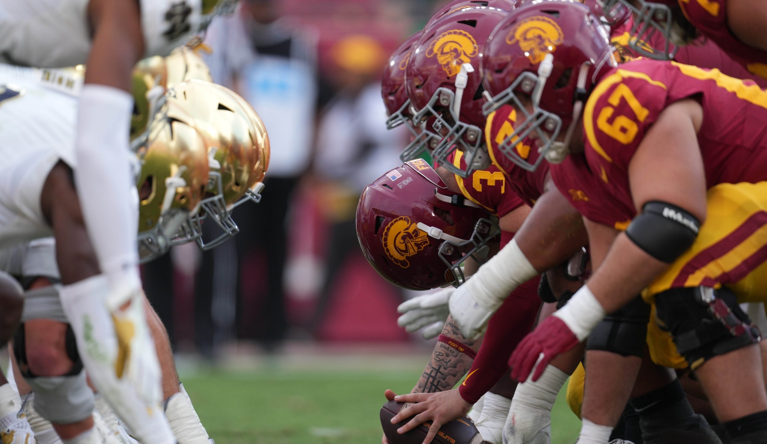 Nov 30, 2024; Los Angeles, California, USA; Helmets at the line of scrimmage as Southern California Trojans long snapper Hank Pepper (31) snaps the ball against the Notre Dame Fighting Irish in the second half at United Airlines Field at Los Angeles Memorial Coliseum. Mandatory Credit: Kirby Lee-Imagn Images