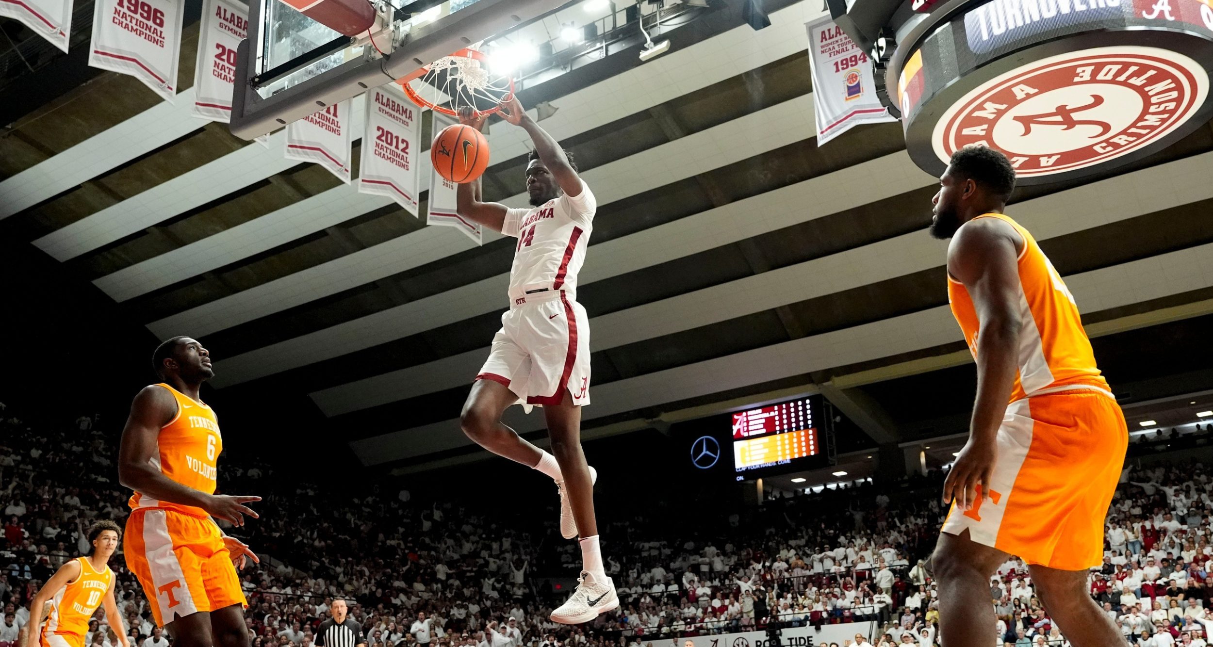 Alabama center Charles Bediako (14) dunks the ball over Tennessee forward Dewayne Brown II (6) at Coleman Coliseum.