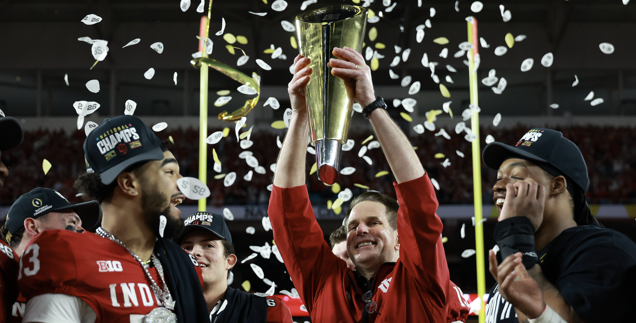 Jan 19, 2026; Miami Gardens, FL, USA; Indiana Hoosiers head coach Curt Cignetti hoists the National Championship trophy in the air after the College Football Playoff National Championship game at Hard Rock Stadium. Mandatory Credit: Mark J. Rebilas-Imagn Images