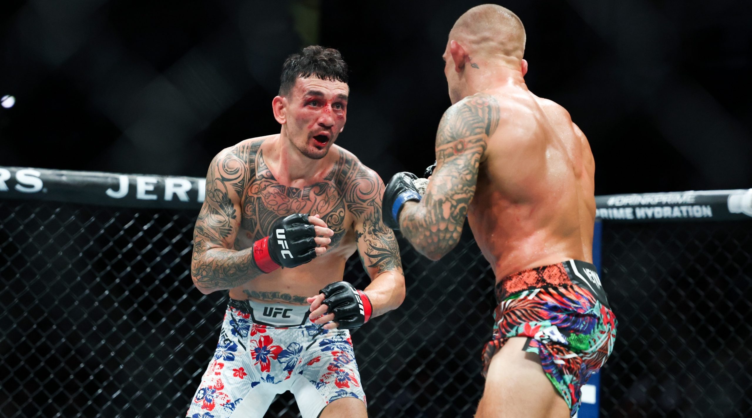 Jul 19, 2025; New Orleans, Louisiana, UNITED STATES; Max Holloway (red gloves) fights against Dustin Poirier (blue gloves) during UFC 318 at Smoothie King Center. Mandatory Credit: Stephen Lew-Imagn Images