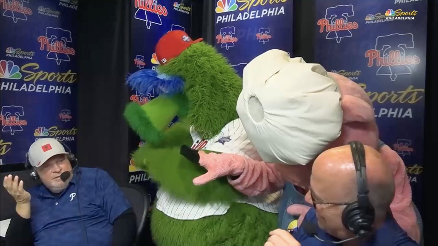 John Kruk in Philadelphia Phillies booth with the Hatfield mascot and Phillie Phanatic