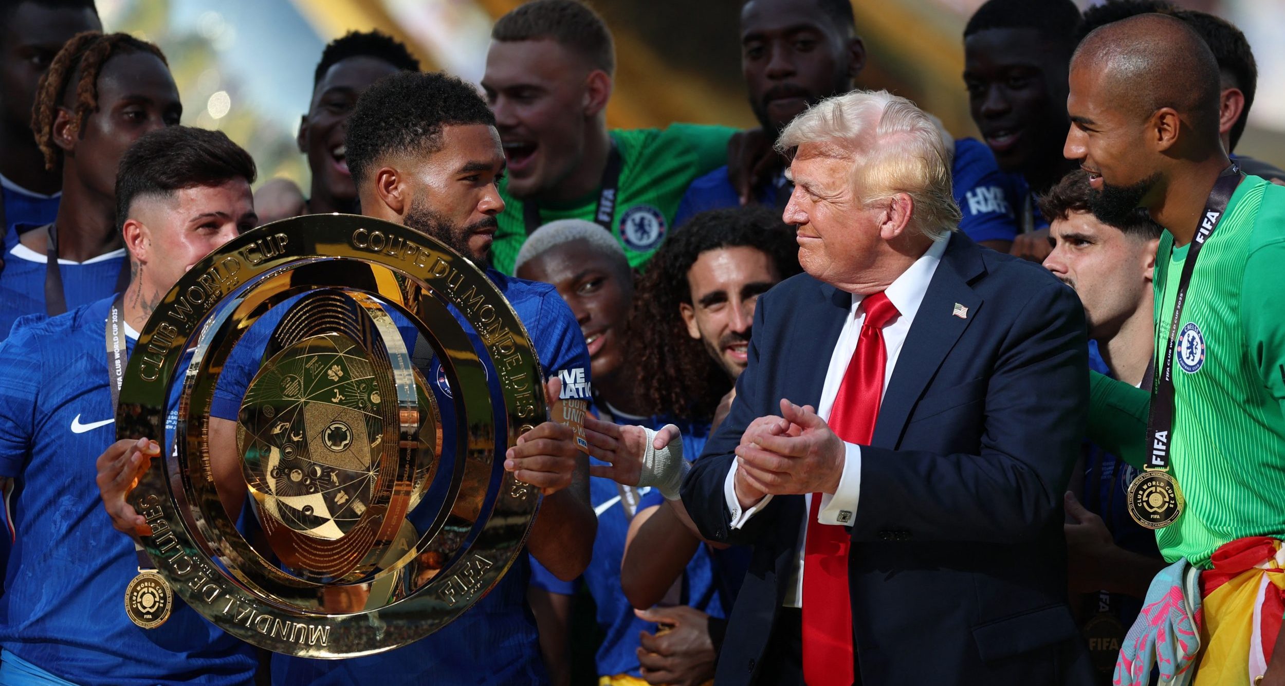 Chelsea FC defender Reece James (24) lifts the trophy as he celebrates with teammates as U.S. president Donald Trump