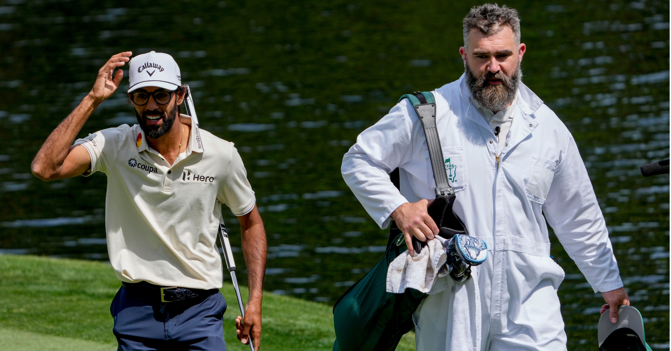 Apr 8, 2026; Augusta, Georgia, USA; Akshay Bhatia and Jason Kelce walk the ninth green during the Par 3 Contest at the Masters Tournament at Augusta National Golf Club. Mandatory Credit: Kyle Terada-Imagn Images